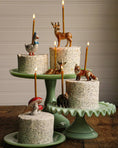 Load image into Gallery viewer, Set of animal-themed cake toppers, including a fox and bear on a green cake stand
