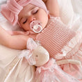 Load image into Gallery viewer, A baby girl sleeping with a pink pacifier and a soft doll in pink and white clothing
